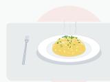 Creamy scrambled eggs in small soft glossy curds on a warm plate, scattered with freshly snipped green chives