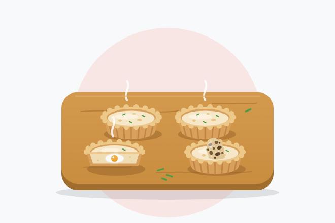 Illustration of four mini quiches on a wooden board, including a cut quiche showing an egg inside