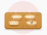 Illustration of four mini quiches on a wooden board, including a cut quiche showing an egg inside