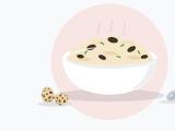Illustration of creamy scrambled eggs with dark truffle slices and chives in a white bowl beside a spoon
